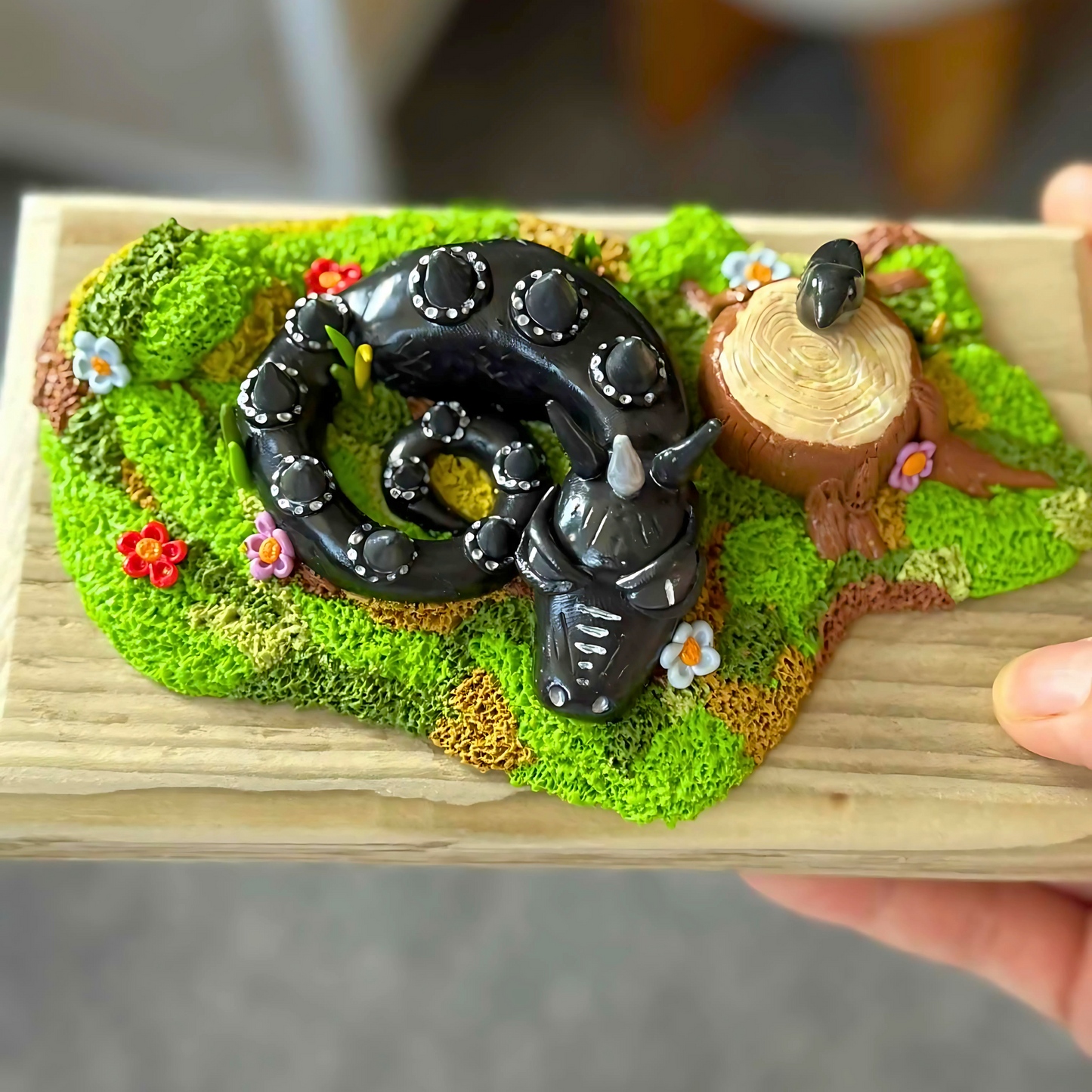 Whimsical Black Dragon Figure Laying In The Grass.